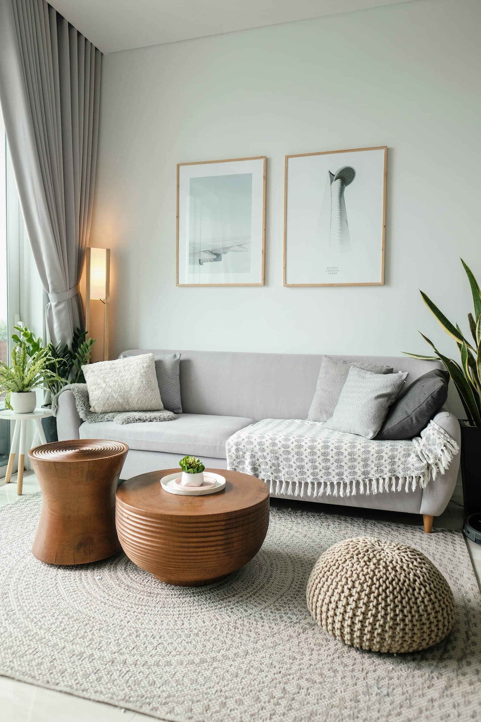 Bright, minimal living room with soft furnishings and large window