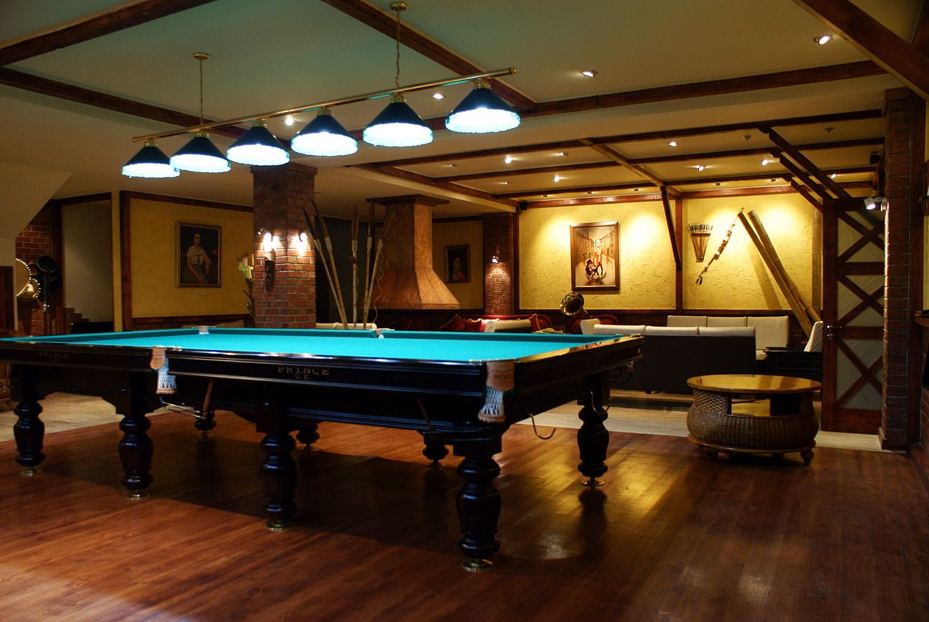 photo of the INTERIOR of a PRIVATE HOUSE with a professional billiard table with a seating area