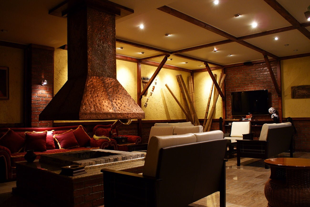 photo of the view of the INTERIOR of a PRIVATE HOUSE on the fireplace area, where guests and hosts gather