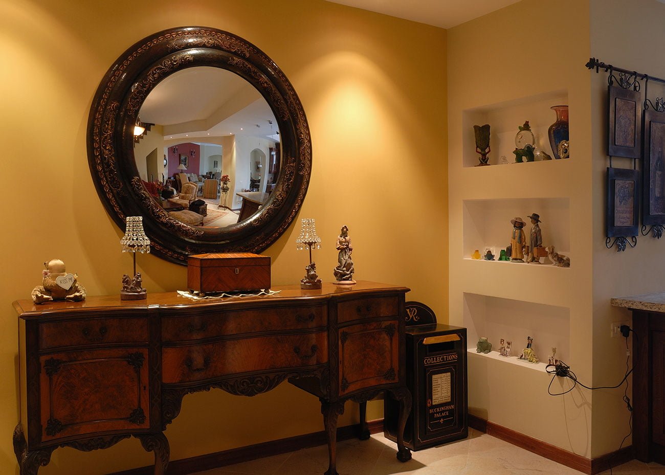 photo of the interior of the hallway with an antique chest of drawers and a mirror in a classic style