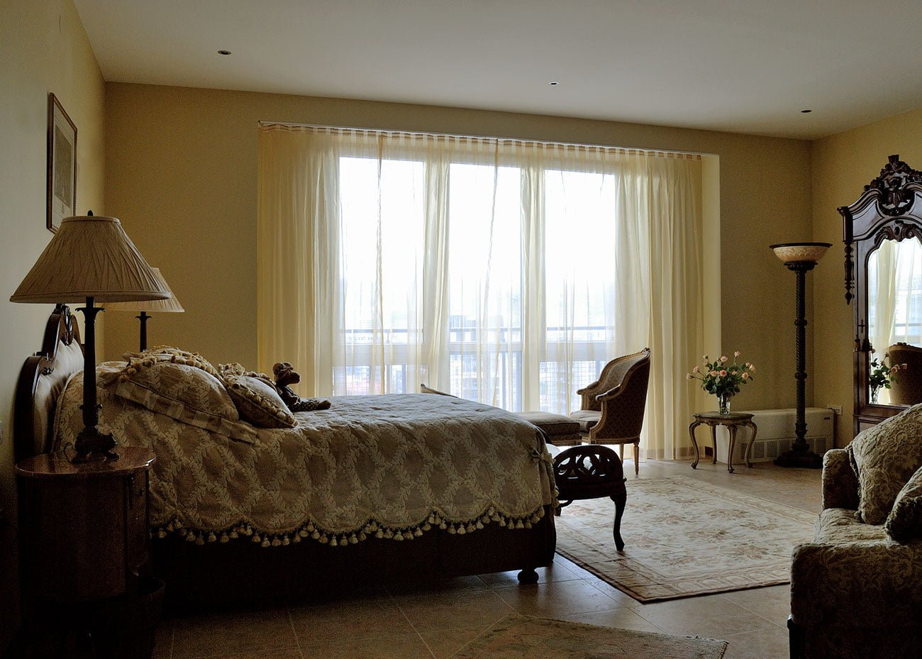 photo of the interior of the master bedroom on the second floor with antique cabinets and lamps