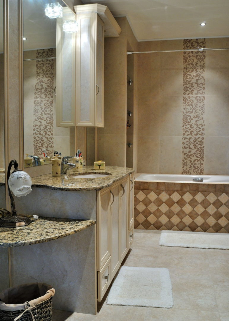 photo of the interior of the master bathroom in beige tones with a bathtub and a washbasin