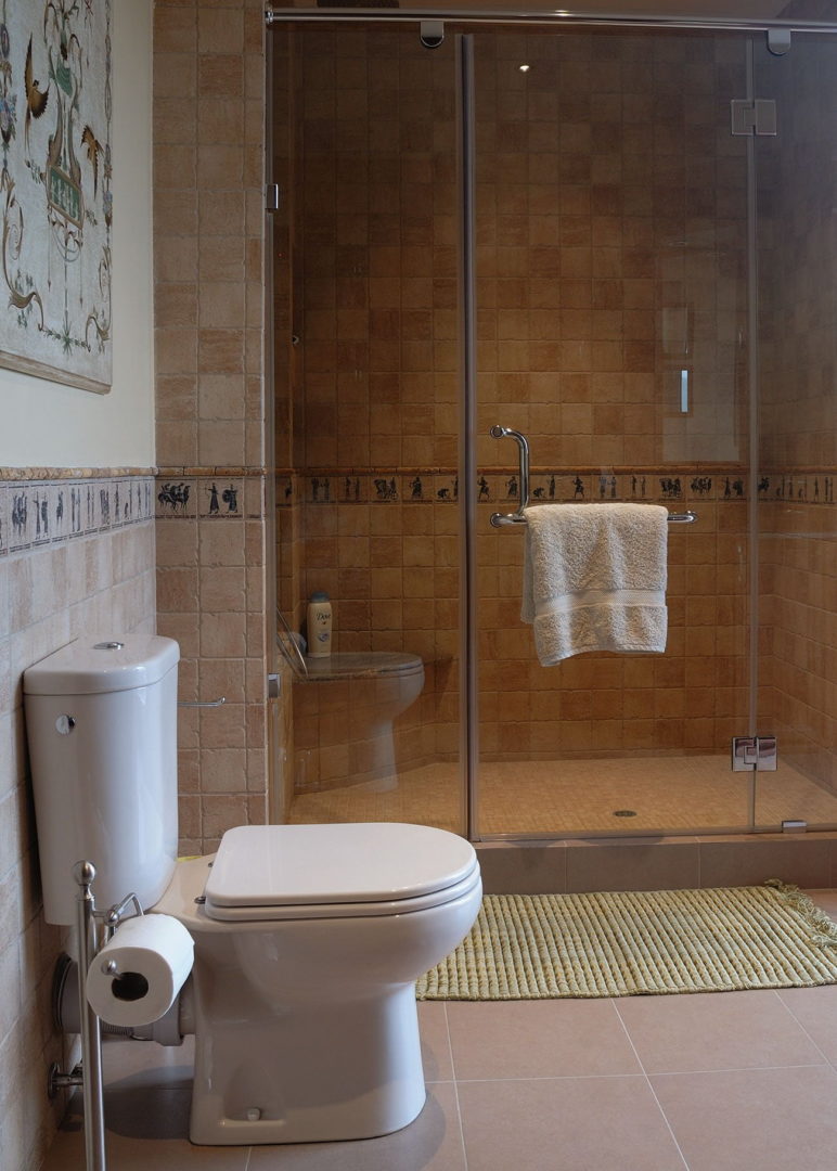 photo interior design of a toilet room in beige light colors with a shower