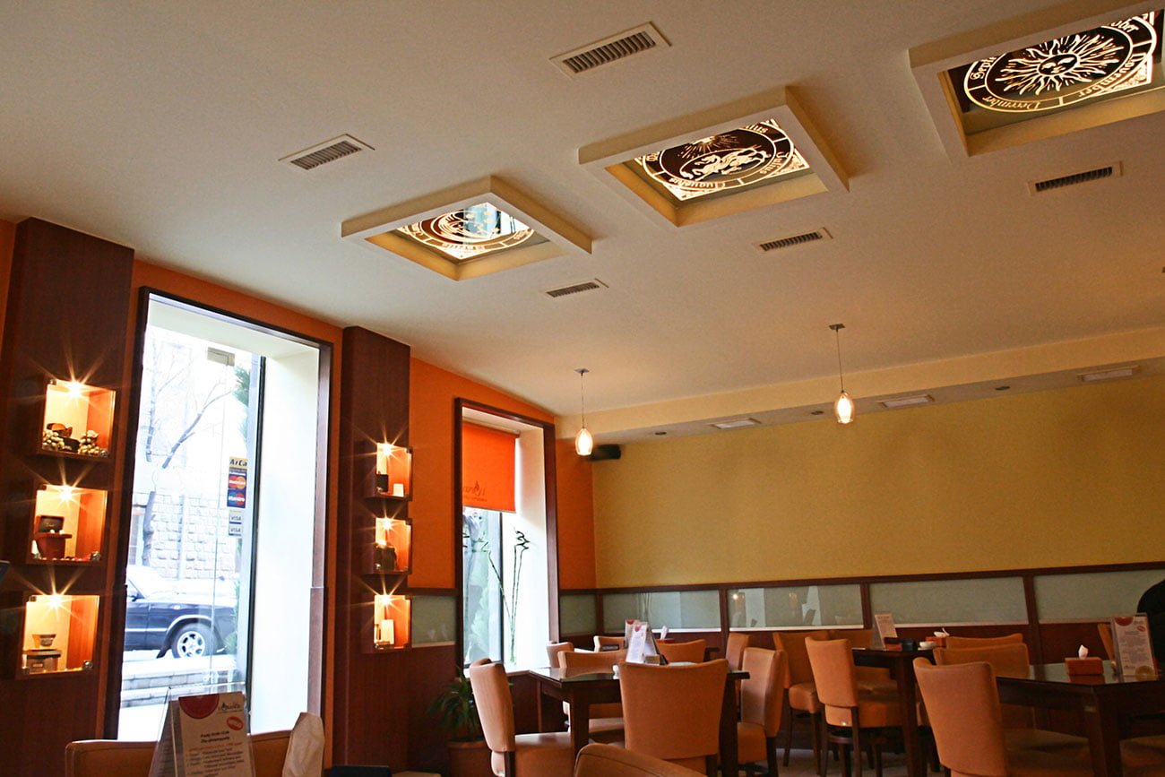 photo of a ceiling decorated with square mirror panels with a sandblasted pattern