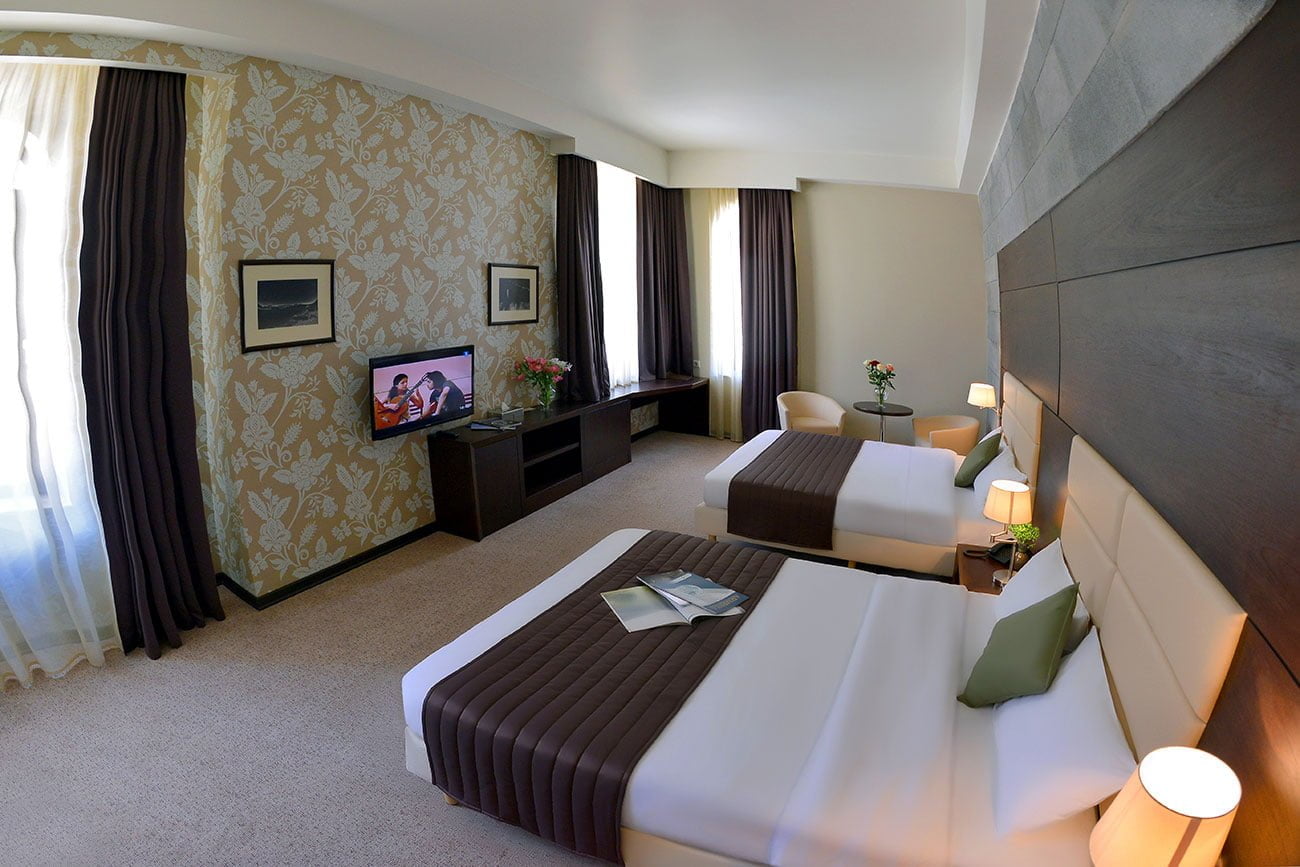 photo of the interior of a double room with two beds in the Vallex Garden hotel
