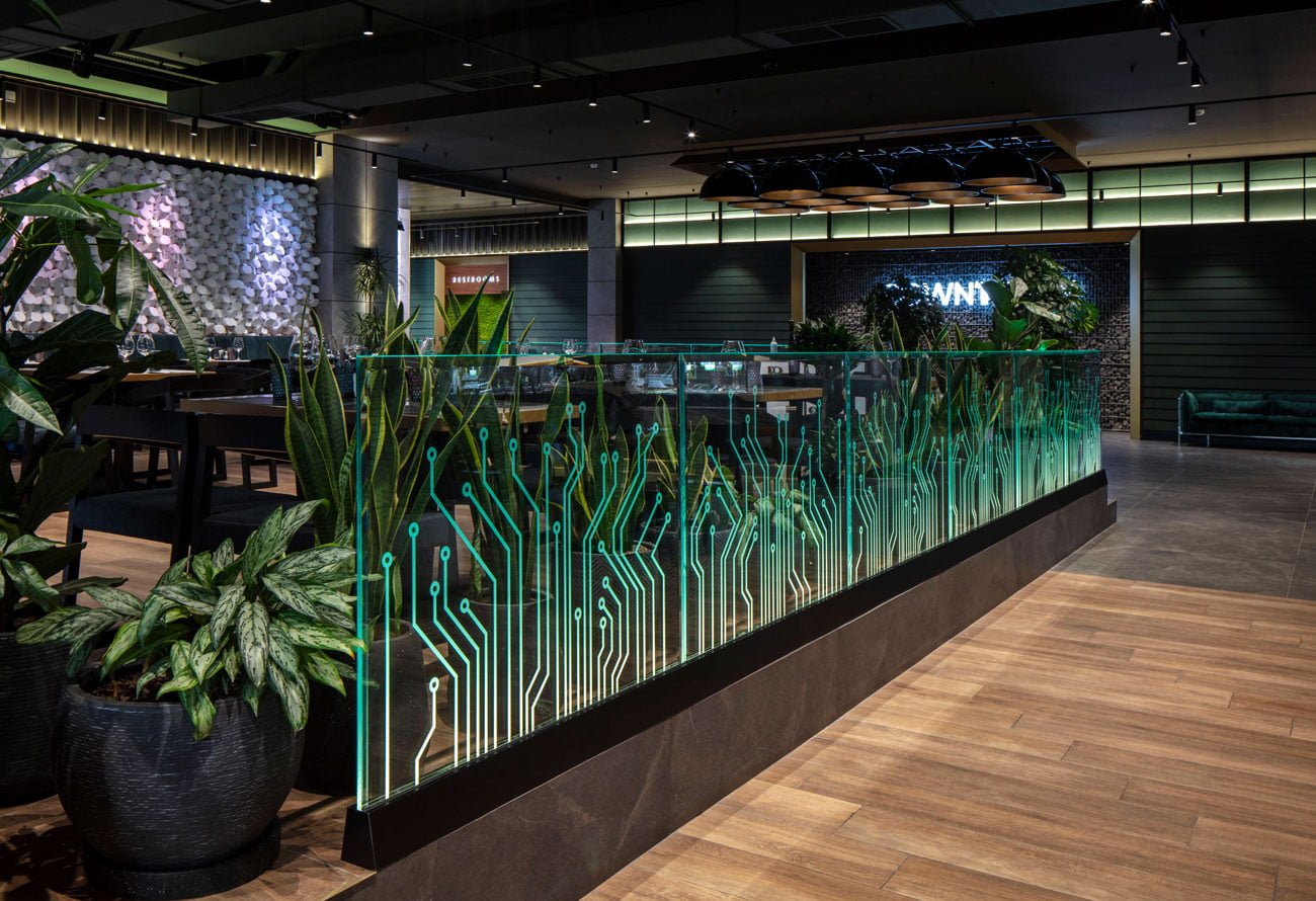 photos of live plants in pots and stylized on glass panels separating the cafe