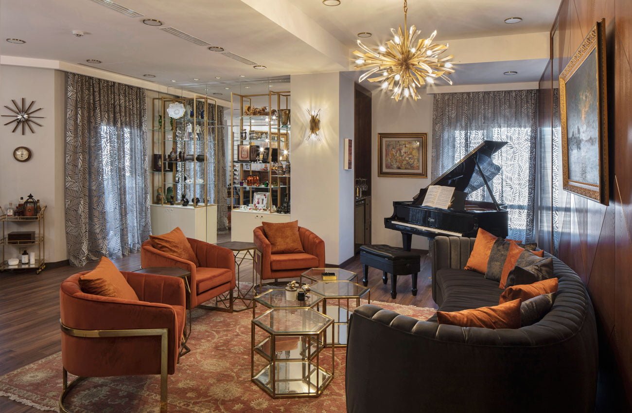 photo of the living room of the center for gathering guests and the whole family with a round sofa and a grand piano