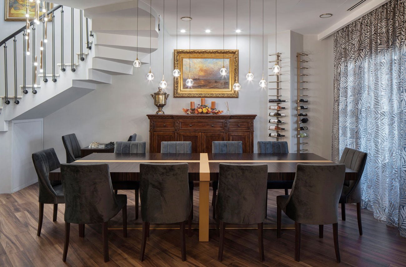 photo of the dining area with a modern table, an antique sideboard and wine racks